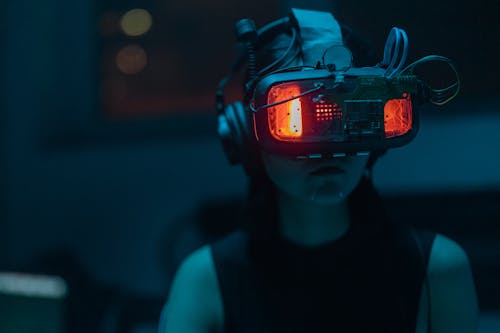 A Woman in a Tank Top Using a VR Headset · Free Stock Photo