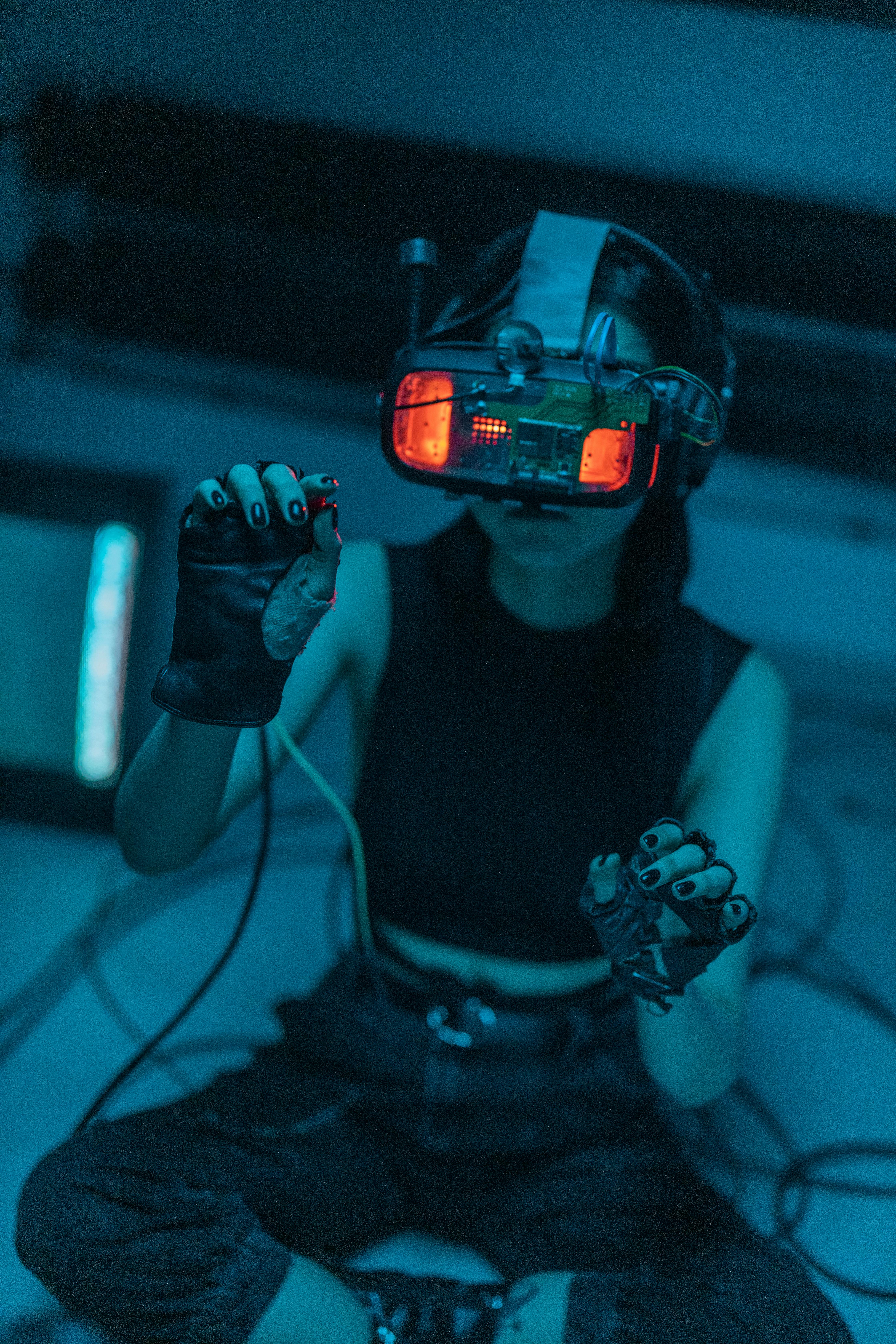 a woman in a tank top using a vr headset