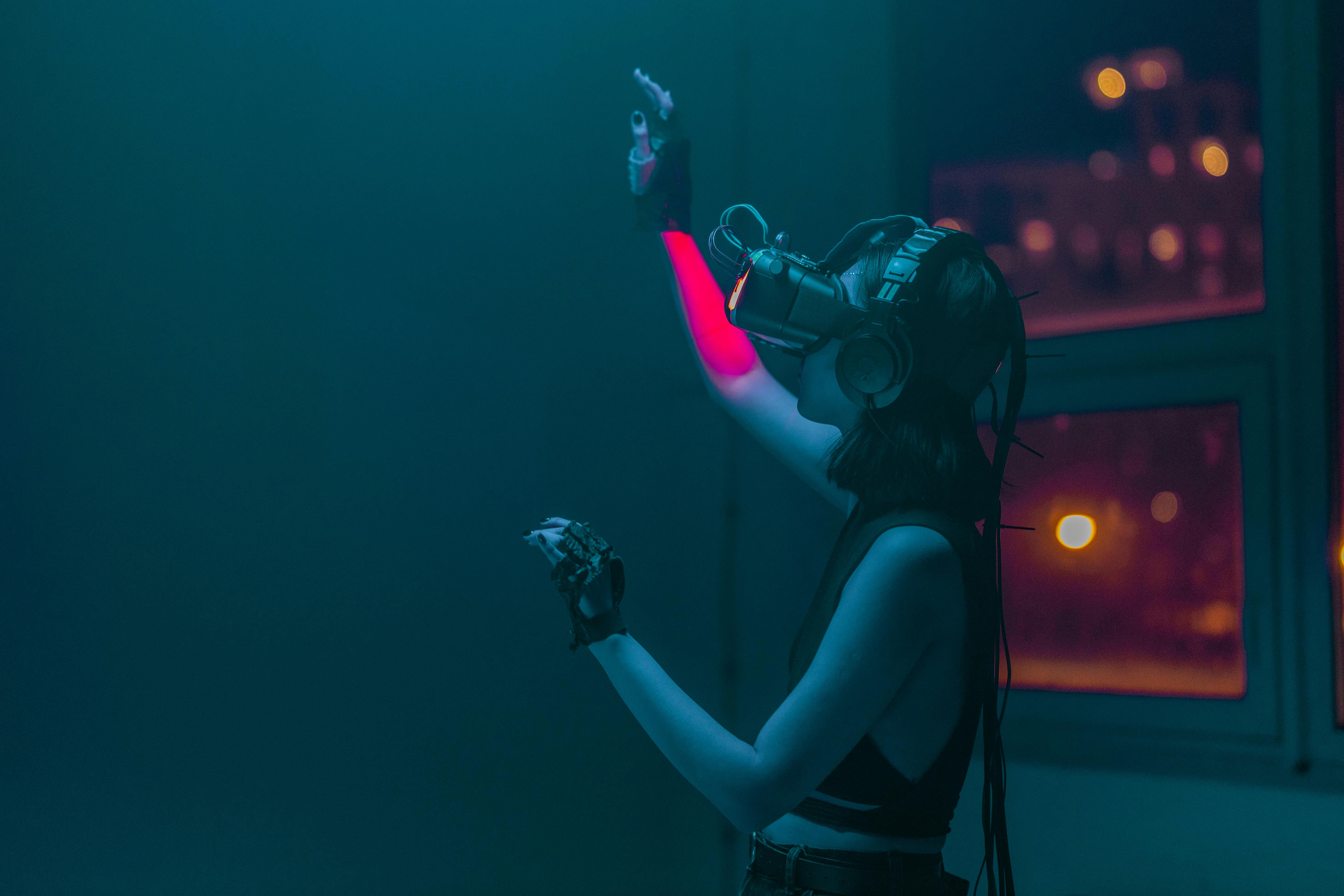 a woman in a tank top using a virtual reality headset