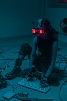 Woman wearing VR headset and gloves with blue and red neon lighting, sitting indoors.