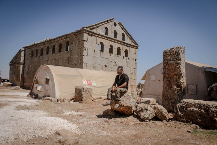 Man Resting On Archaeological Site