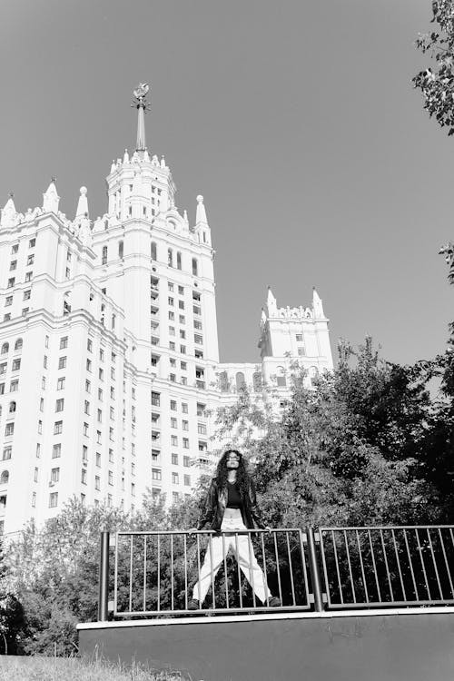 Woman Standing on the Background of the Kotelnicheskaya Embankment Building, Moscow, Russia 