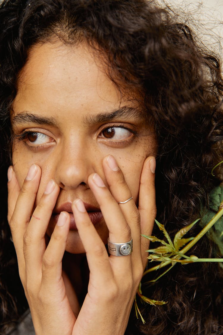 A Woman Touching Her Face 