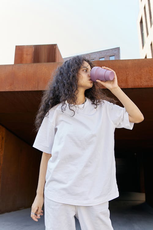 A Girl Drinking on a Plastic Cup