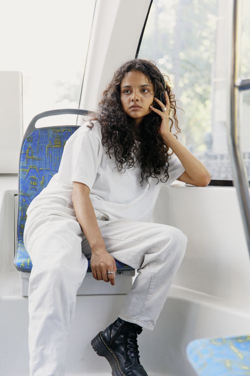 Free Stylish woman in casual street wear posing inside a city bus. Stock Photo
