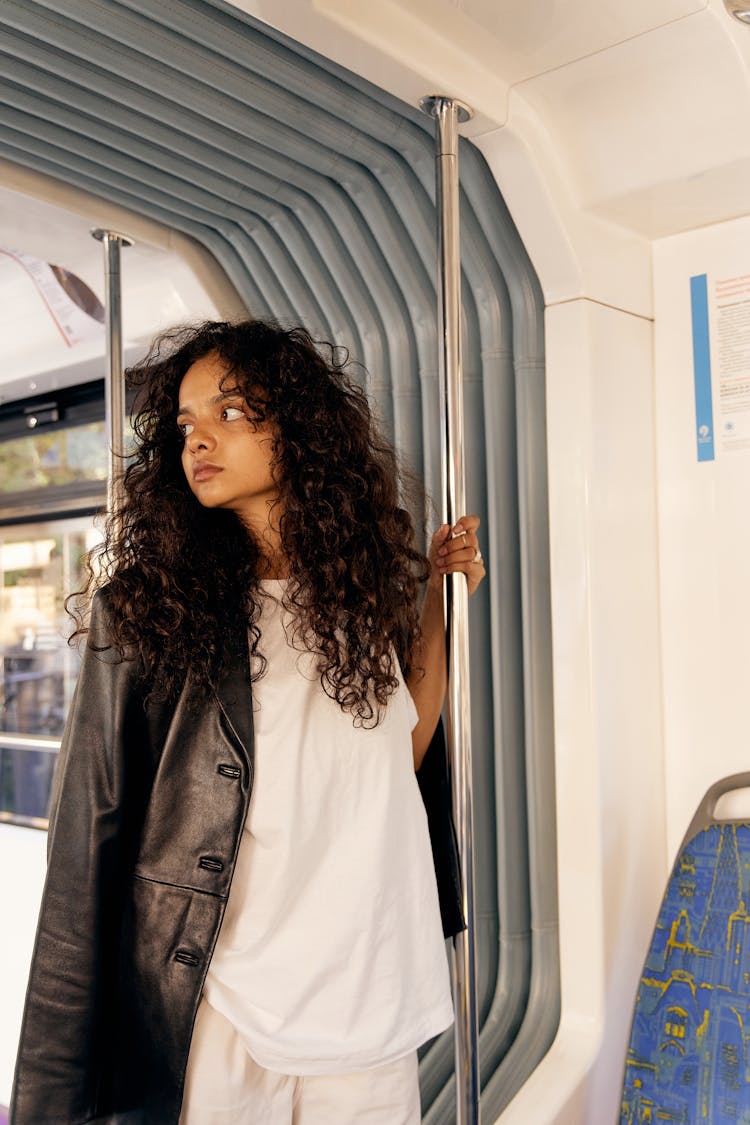 A Woman Holding On The Bus Grab Bar