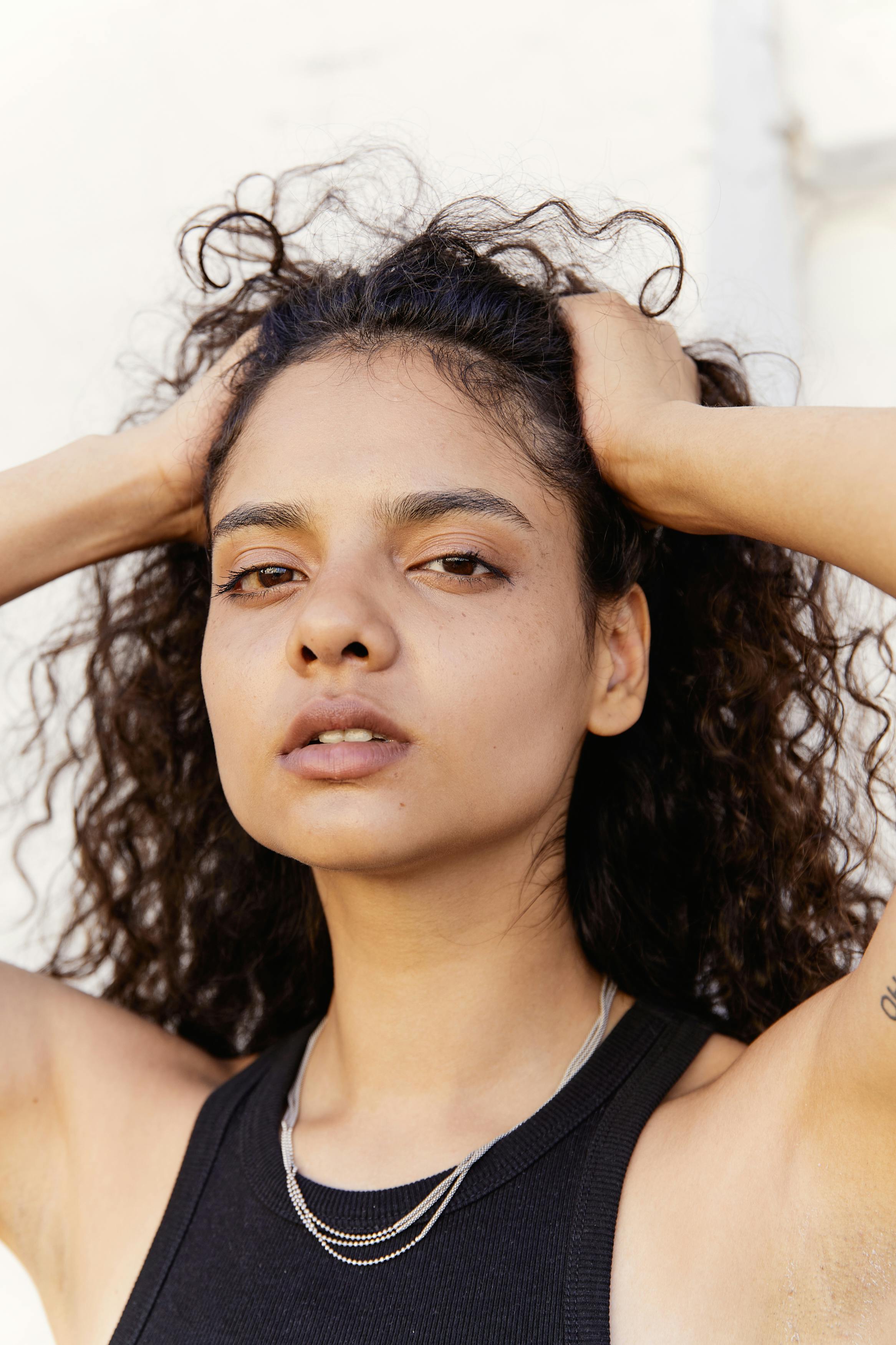 portrait of a young woman in black tank top