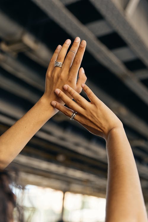 Silver Rings on a Person's Fingers