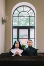 Man in Black Suit Standing Beside Woman in White Hijab