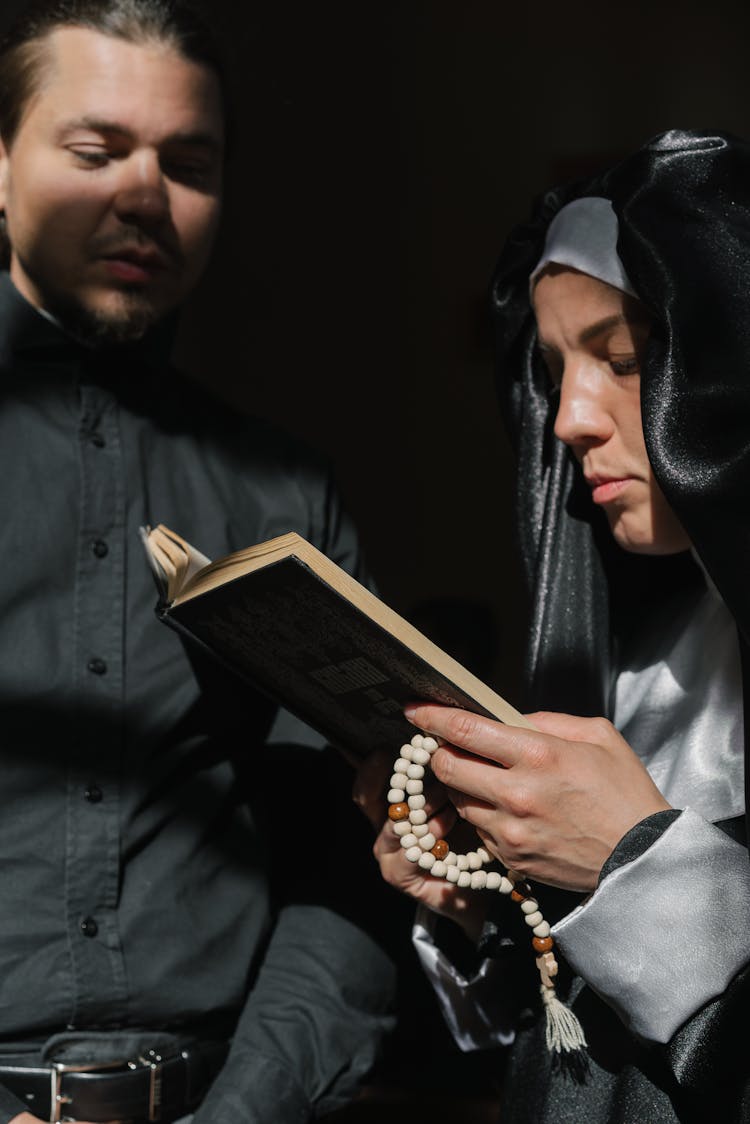 Man And Woman Standing Together Reading A Holy Book