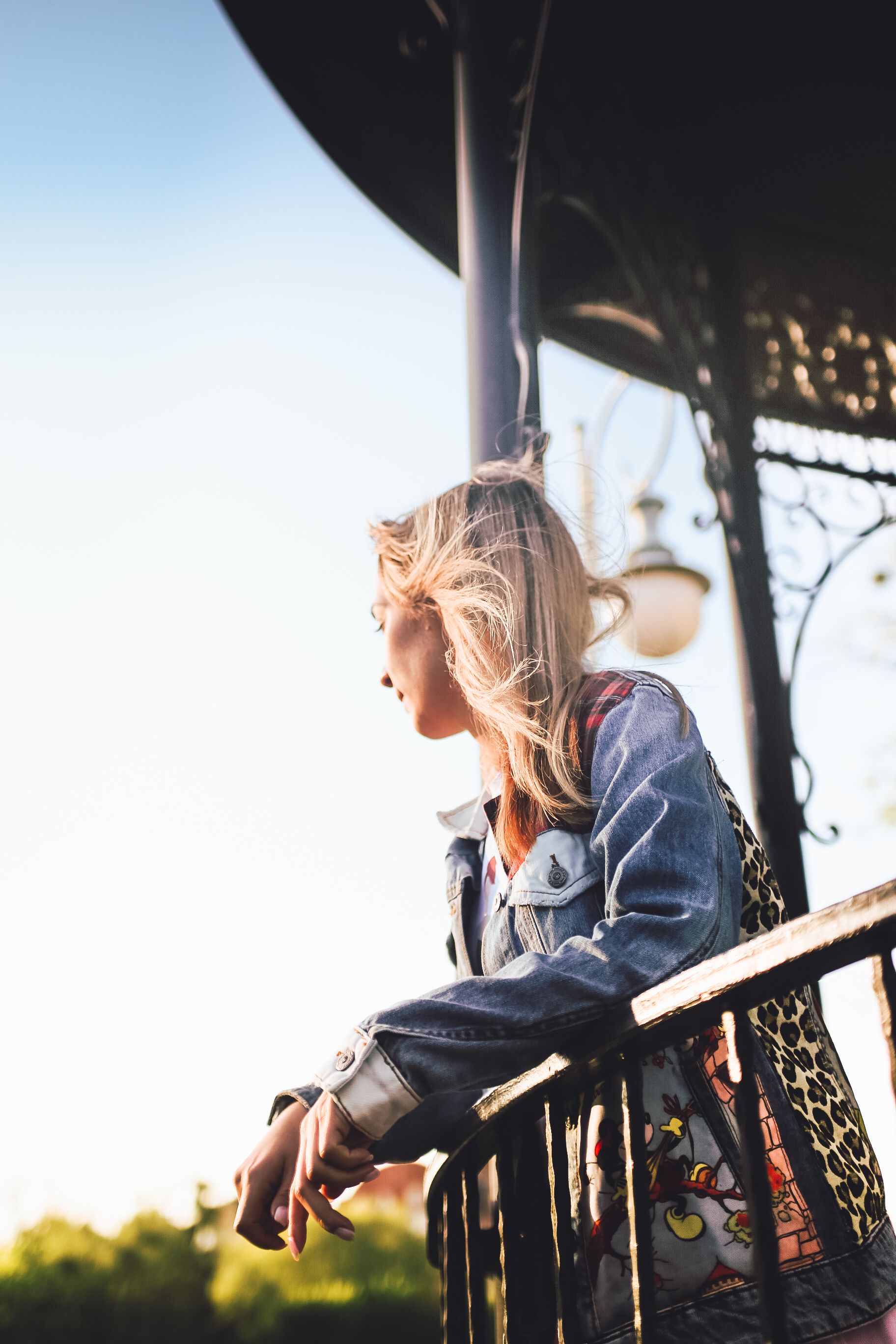 Slumped Against Railing Woman Leaning against Railing of Gazebo · Free Stock Photo