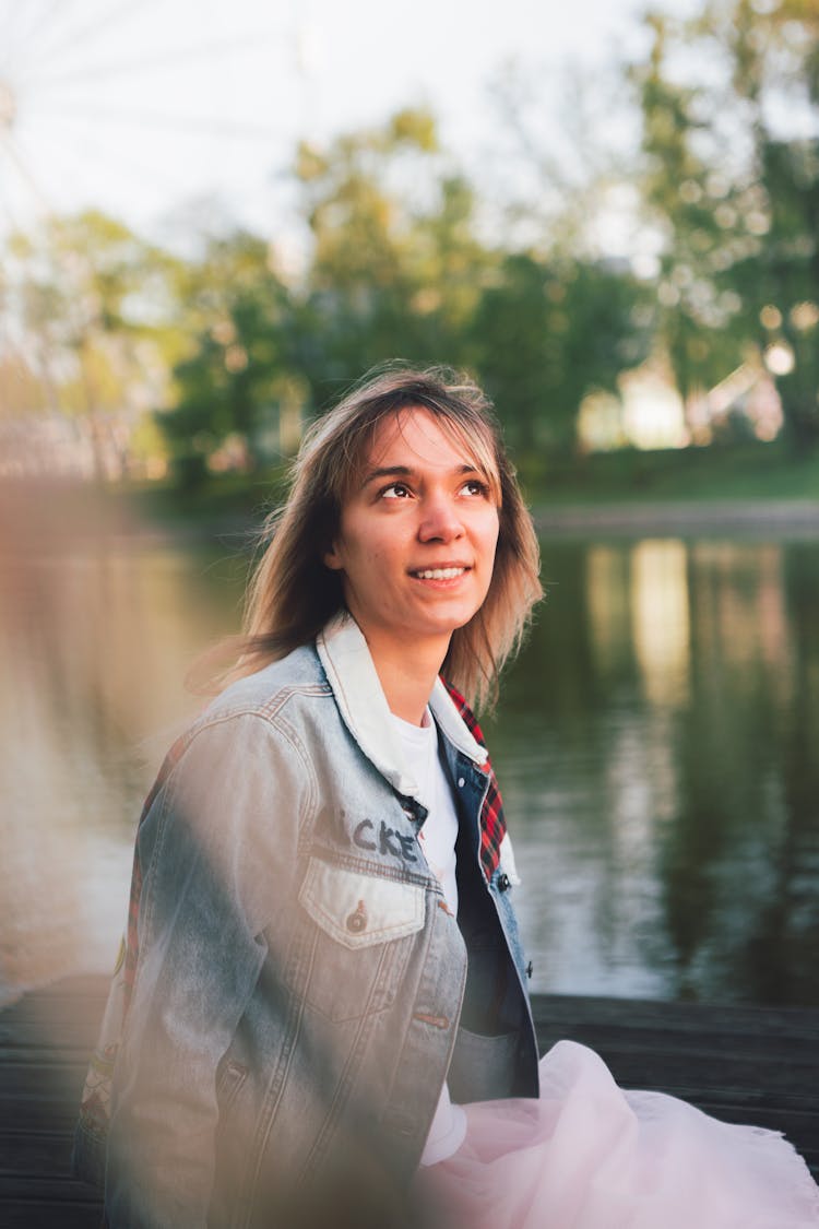 A Woman In Denim Jacket Looking Up