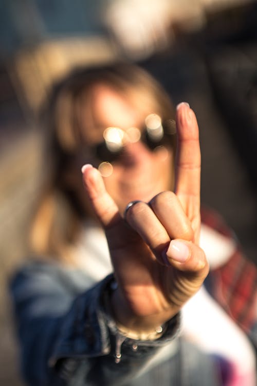 A Woman Doing a Rock and Roll Hand Gesture