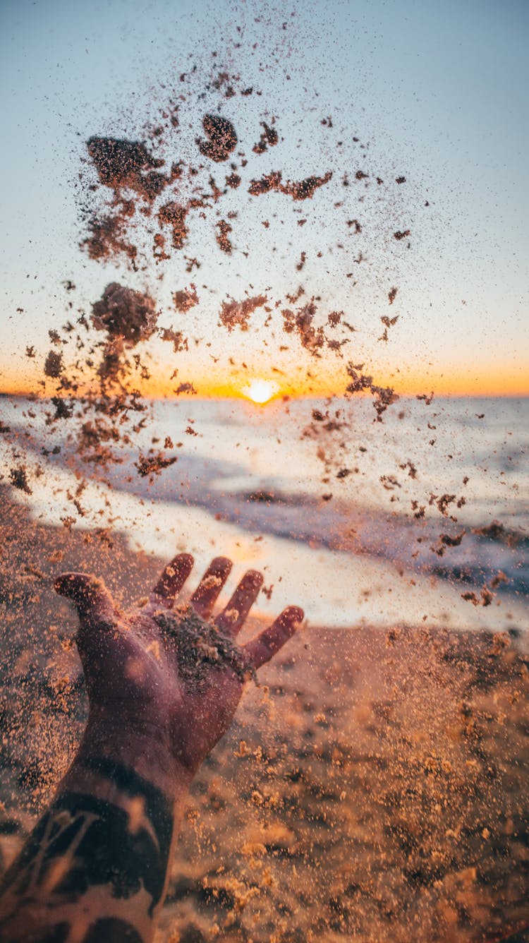 Hand Throwing Sand