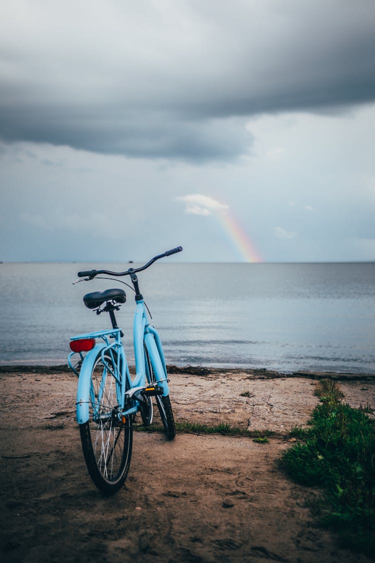 Rainbow Over A Lake And A Bike