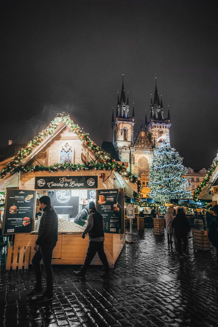 Christmas Market By Night And Church In Background