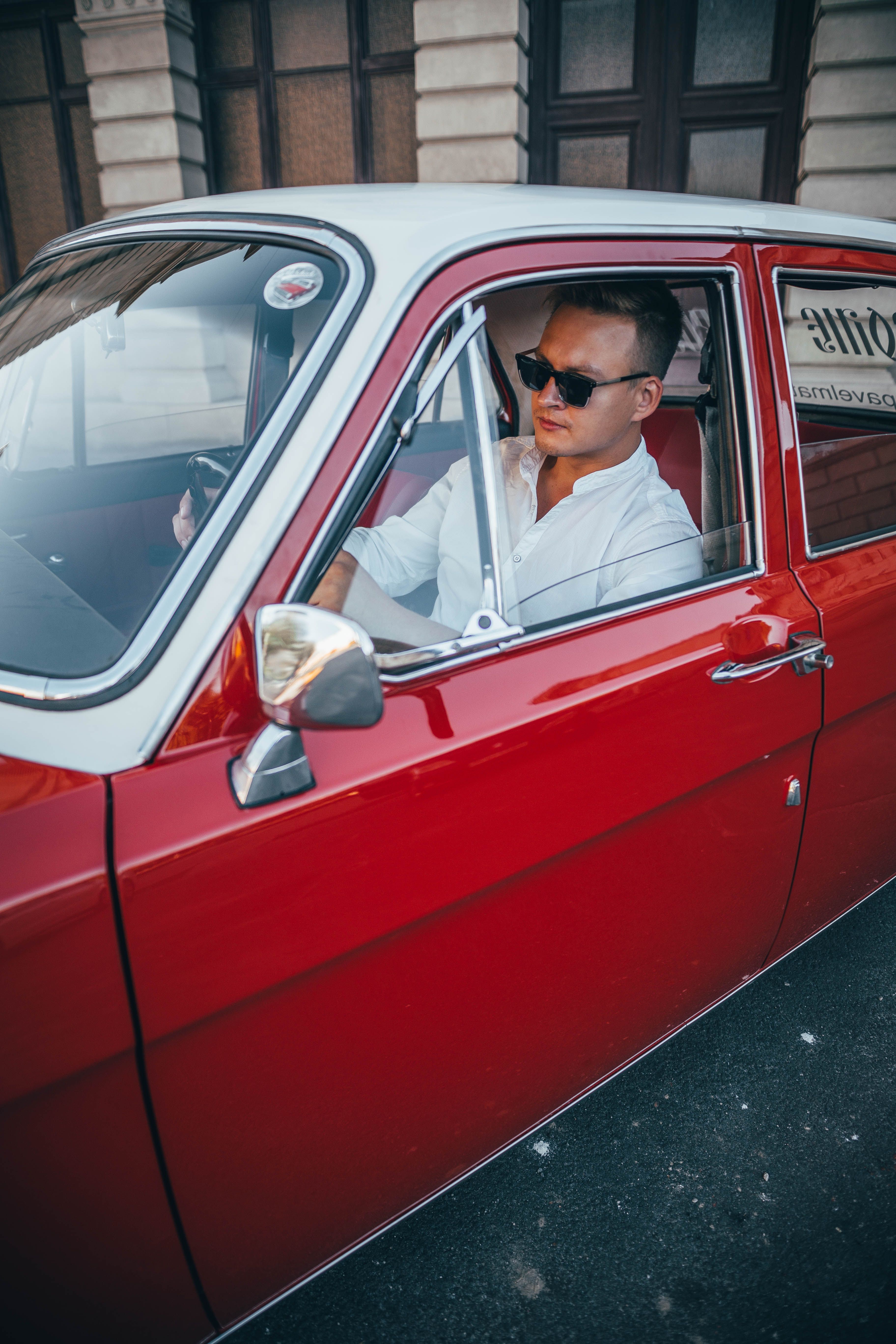 Man in White Button Up Sitting Inside a Red Car · Free Stock Photo
