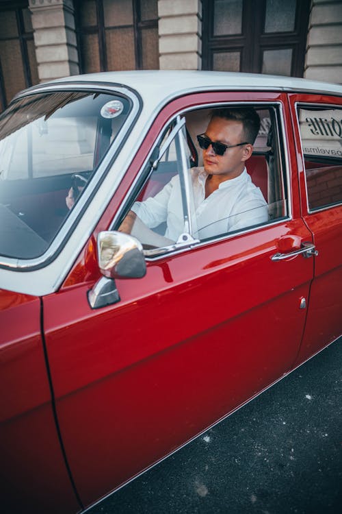 Free Man in White Button Up Sitting Inside a Red Car Stock Photo