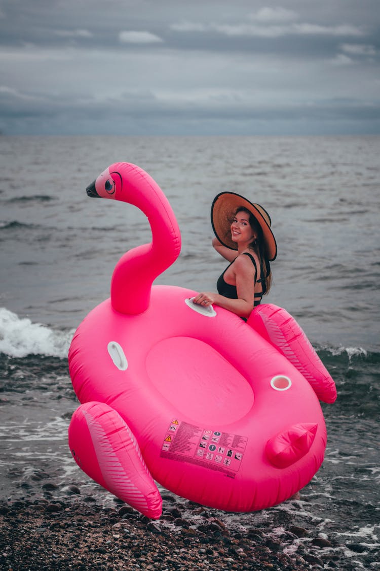 Girl On The Beach With An Inflatable Bird 