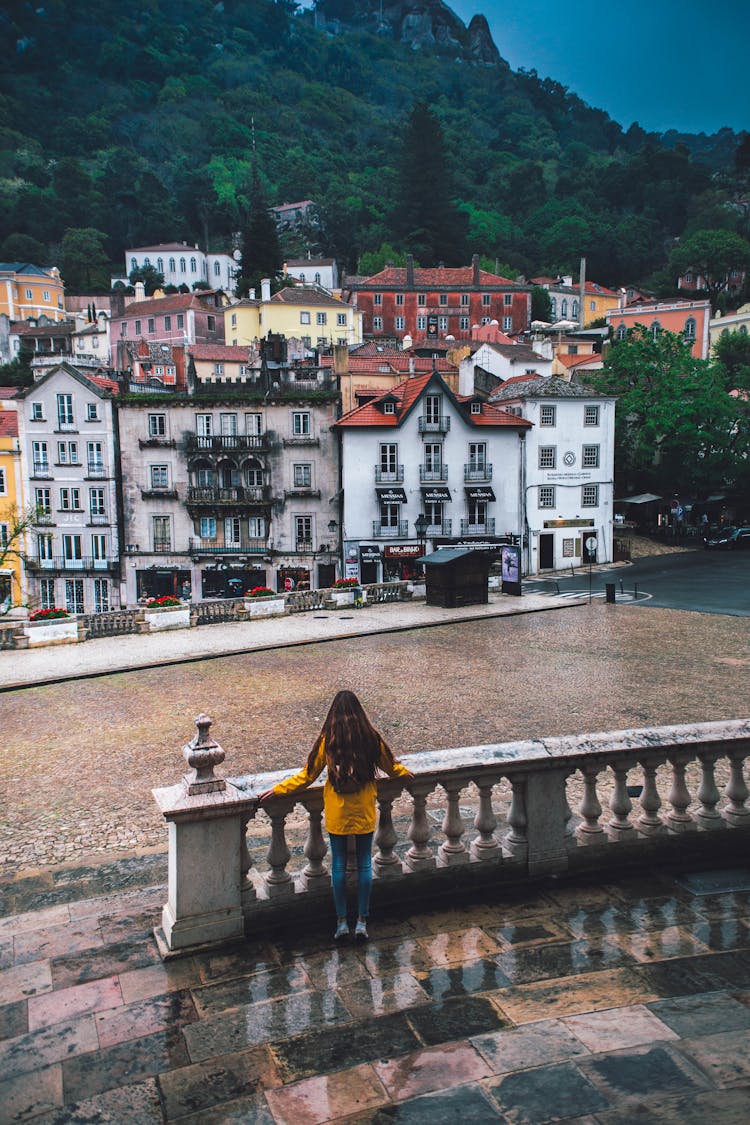 Woman Standing On Marble Plaza Overlooking City