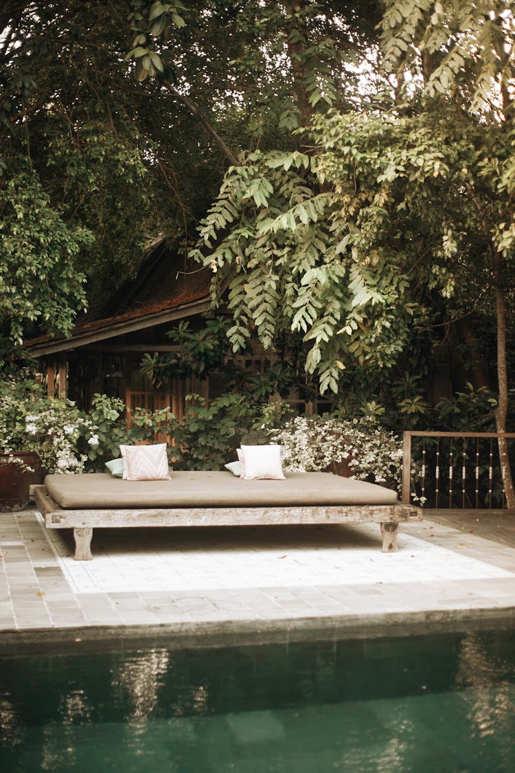 Bed On A Patio Beside Swimming Pool 