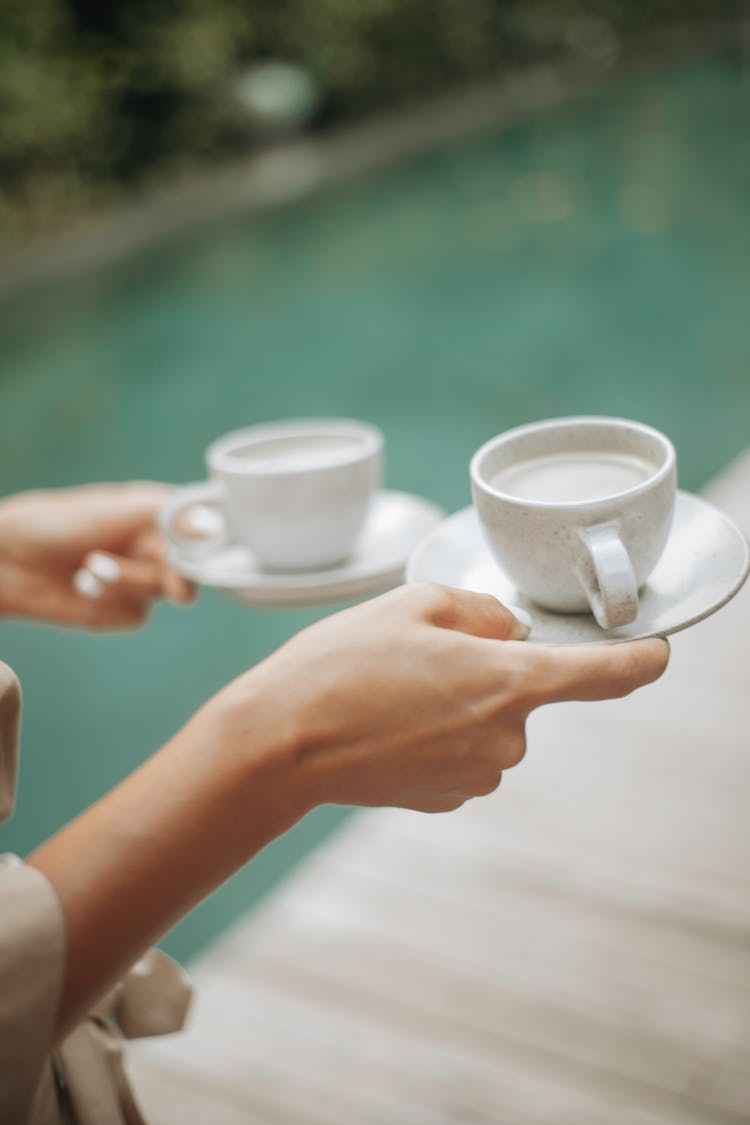 Woman Holding Two White Ceramic Cups