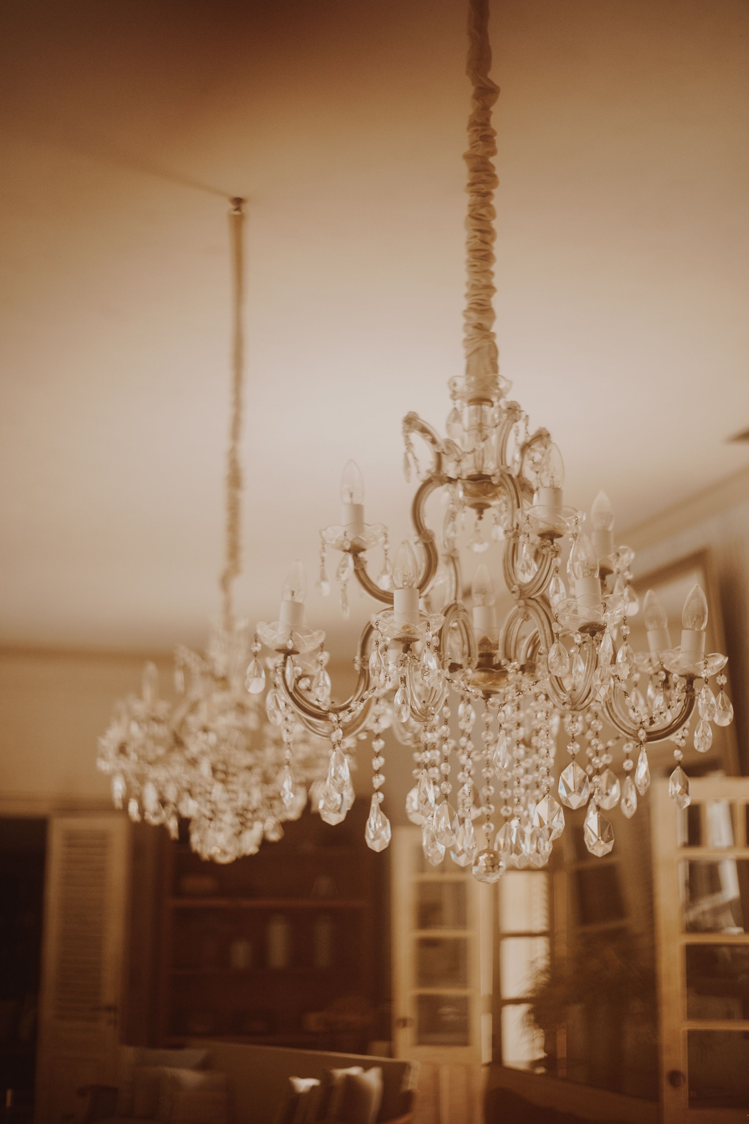 Silver Metal Chandelier Hanging on White Ceiling · Free Stock Photo - Hanging Metal Chandelier