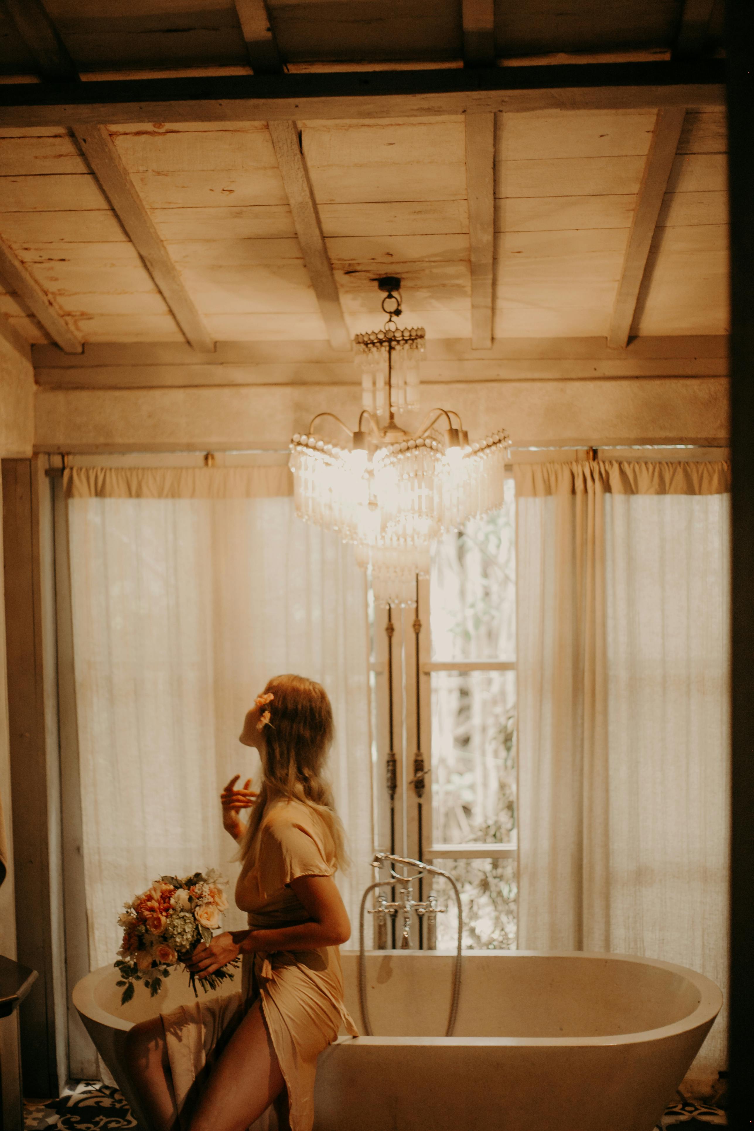 Romantic scene of a woman in a serene bathroom holding flowers, soft lighting creates a warm ambiance.