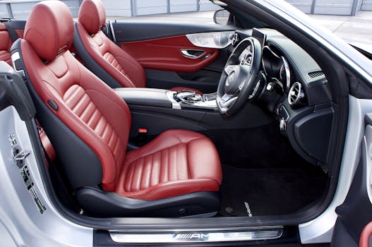 Explore the stylish red leather seats of a sleek convertible car interior, showcasing elegance.
