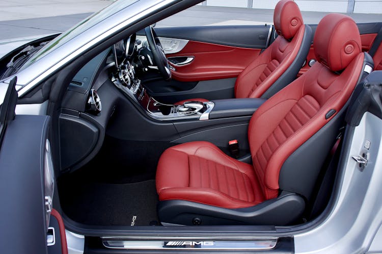 A Car Passenger Seat With A Red Leather Cover