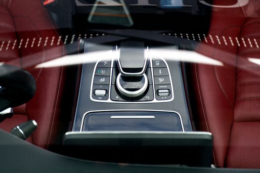 Close-up view of a luxury car interior highlighting the sleek control buttons and design.