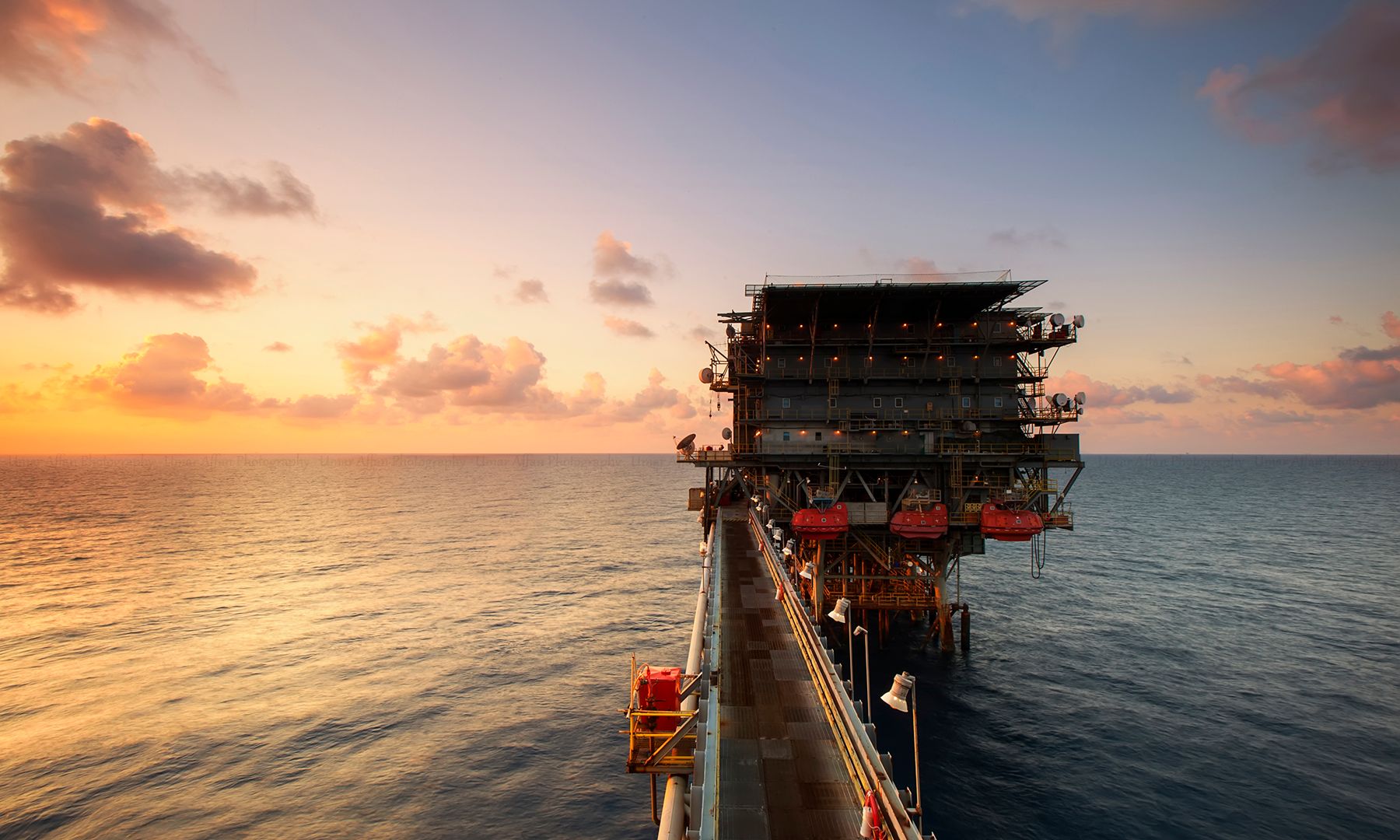 Offshore oil platform at sunset