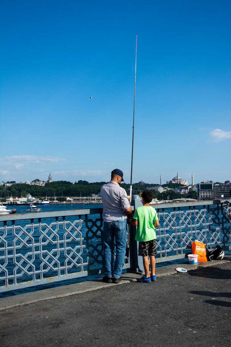 A Man And Boy Doing Fishing Together