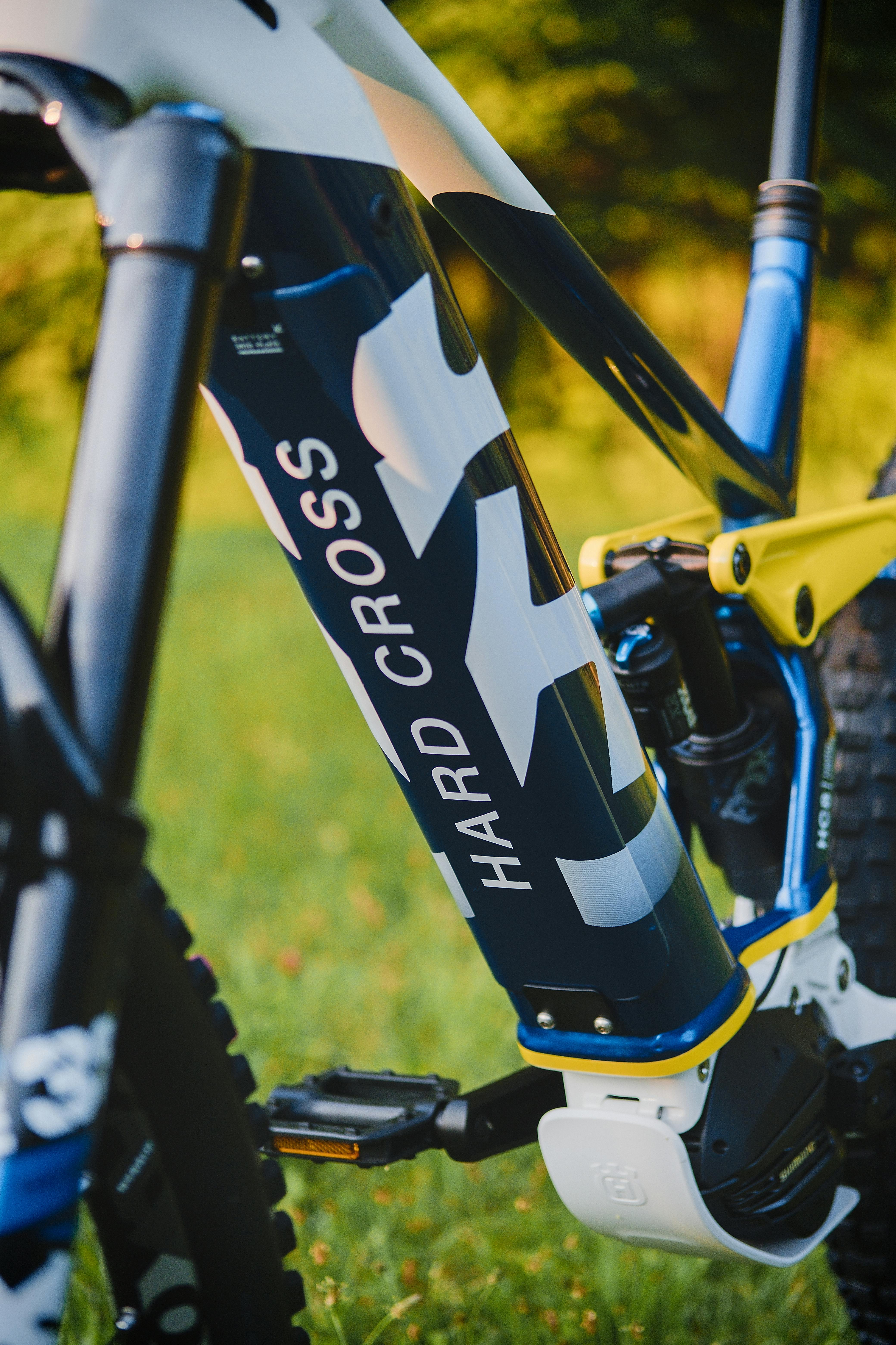 Detailed view of a Hard Cross mountain bike frame in an outdoor setting.