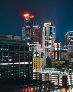 Stunning night view of the illuminated Minneapolis skyline featuring iconic skyscrapers and city lights.