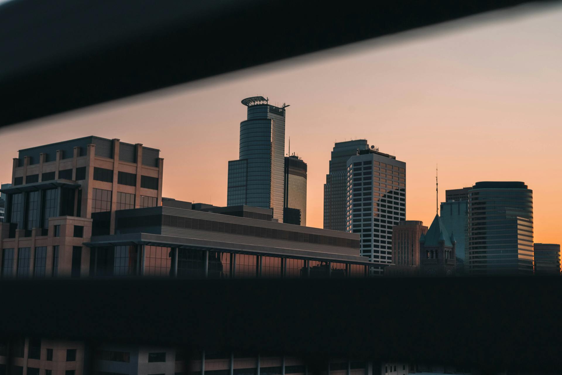 Captivating view of Minneapolis skyline during sunset, showcasing modern architecture in a serene twilight.