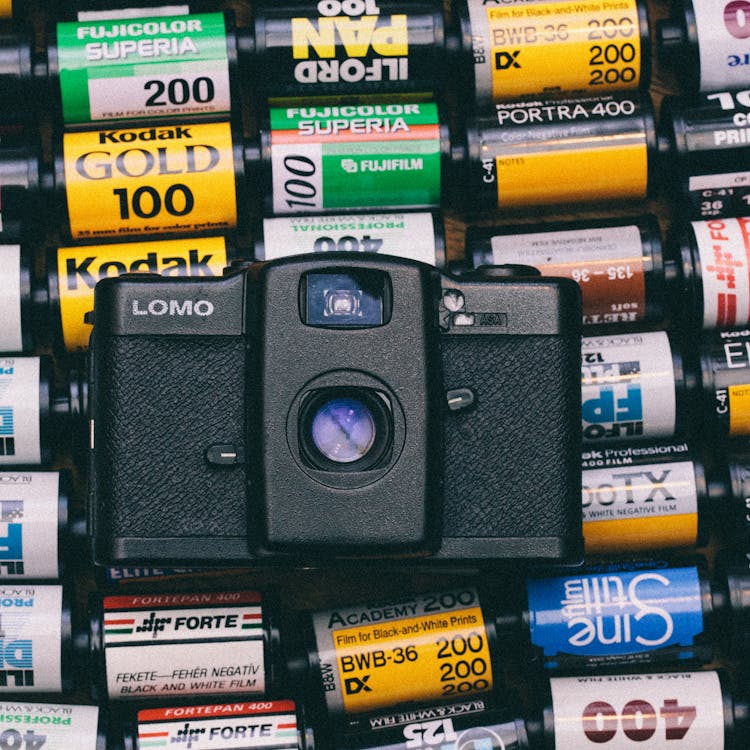 Free Black Lomo Camera on Top of Photo Films Lot Stock Photo