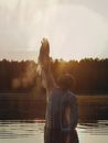 A Man in the Lake Reaching for the Sky