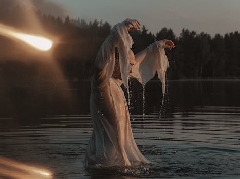 A mystical scene of a person in flowing white attire standing in a tranquil lake during sunset.