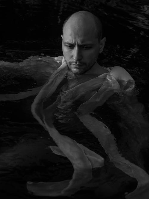 A Grayscale of a Man in the Water