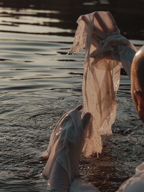 A Man Wearing a Vintage White Long Sleeved Shirt in a Lake