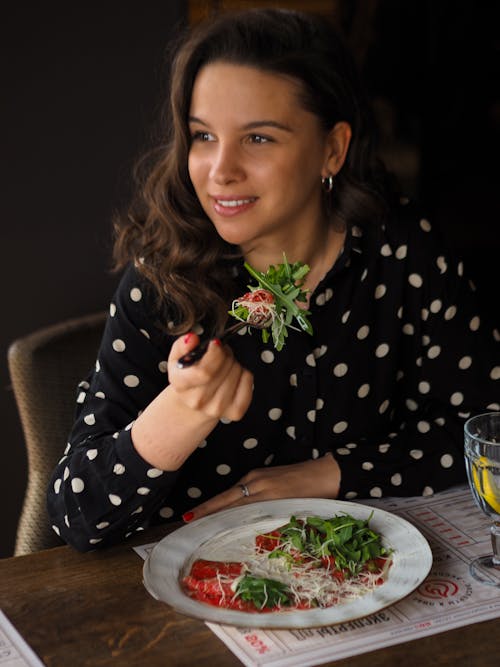 A Woman Holding a Fork with Fresh Salad