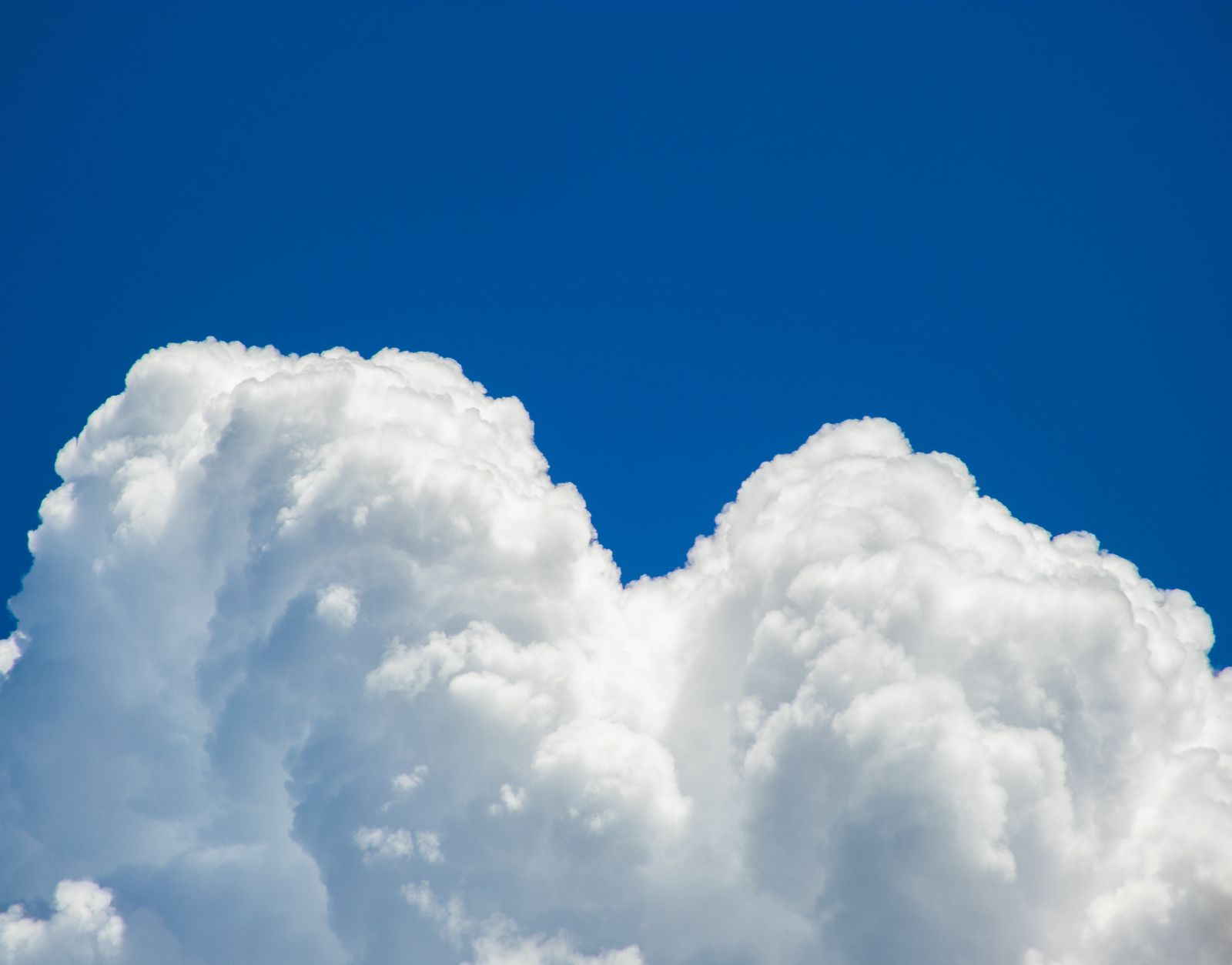 Cumulus clouds in a bright sky — photo by Nothing Ahead on Pexels
