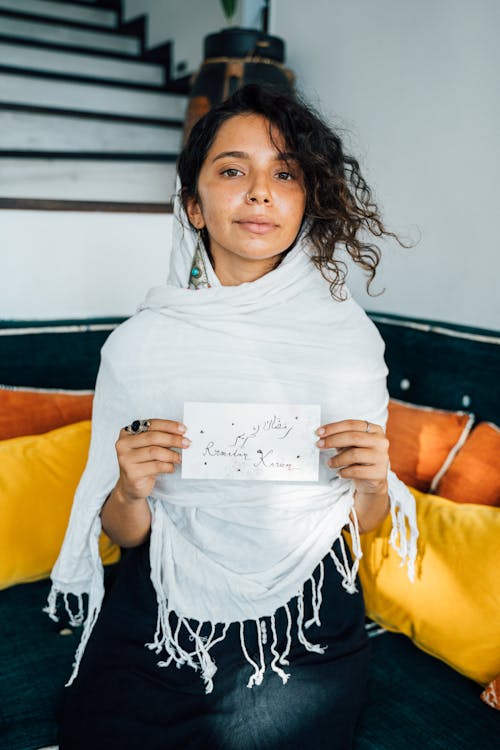 Woman in White Scarf Holding White Paper