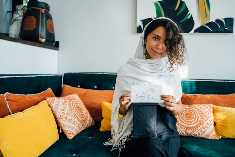 A Woman Holding A Card With A Message