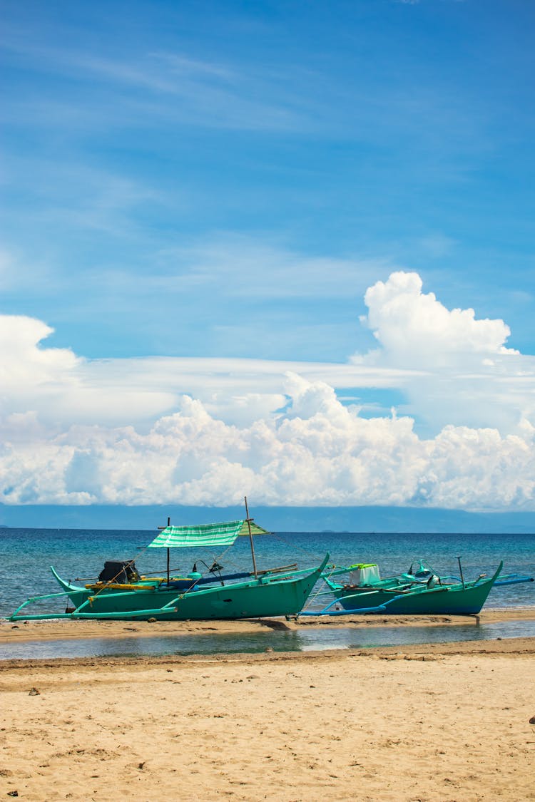 Two Green Motor Boats Beside The Beach