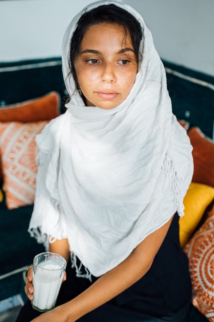 A Woman Holding A Glass Of Milk 