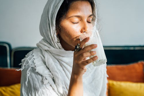 Woman in a Hijab Drinking Milk 