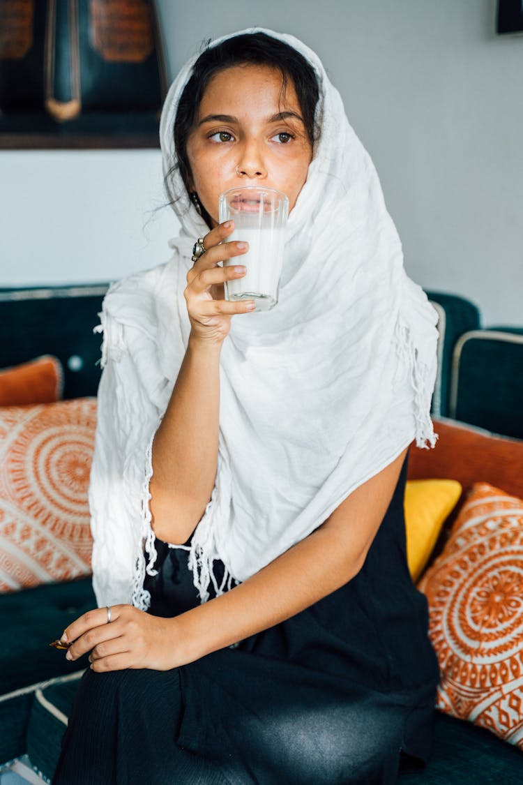 A Woman Holding A Glass Of Milk 