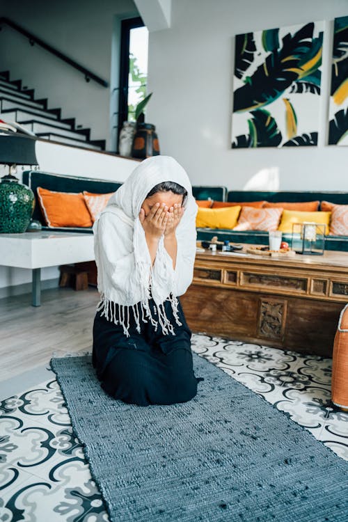 Woman with Her Hands on Her Face While Praying